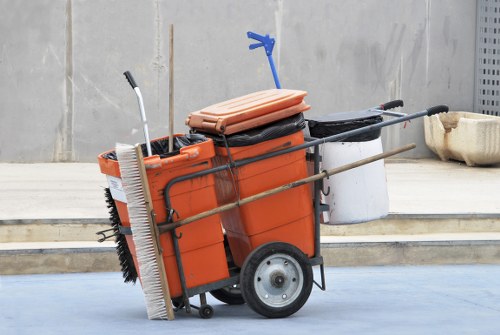 Crew loading bins into a covered vehicle operated by an insured waste company